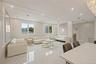 Living room featuring a decorative wall, marble tiled floors, and recessed lighting