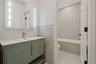 Bathroom featuring vanity and tile walls