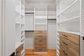 Walk in closet with light wood-style flooring