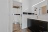 Bathroom with vanity, marble finish floors, and washtub / shower combination