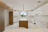 Kitchen with a kitchen island, modern cabinets, white cabinets, pendant lighting, and recessed lighting