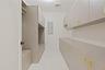 Walk in closet with electric panel and light colored carpet