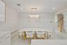 Dining room with recessed lighting, stairs, radiator, a chandelier, and light marble finish flooring