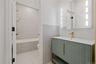 Full bath with vanity, tile walls, and tiled shower / bath