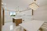 Kitchen with modern cabinets, a kitchen island, recessed lighting, white cabinets, and pendant lighting
