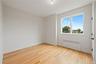 Unfurnished room with radiator heating unit and light wood finished floors