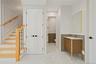 Full bathroom with wainscoting, vanity, marble finish floors, and a decorative wall