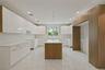 Kitchen featuring a center island, modern cabinets, light marble finish floors, white cabinetry, and recessed lighting