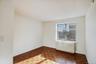 Empty room featuring radiator heating unit and baseboards