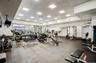 Workout area featuring a paneled ceiling and baseboards