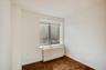 Spare room featuring radiator and baseboards