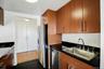 Kitchen featuring appliances with stainless steel finishes, brown cabinetry, and dark countertops
