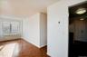 Unfurnished room featuring radiator, a textured ceiling, and electric panel