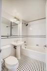Full bath with tile walls, shower / washtub combination, and tile patterned flooring