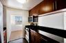 Kitchen featuring stainless steel appliances and dark tile patterned flooring