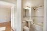 Bathroom featuring shower / bath combination and tile walls