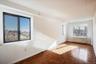 Spare room with a skyline view, a textured ceiling, and radiator