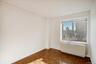 Unfurnished room featuring radiator heating unit and a skyline view