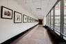 Hallway with baseboards and expansive windows