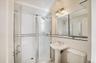 Full bath with a shower stall, tile walls, and tasteful backsplash