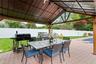 Fenced backyard with a grill, a patio area, and outdoor dining area
