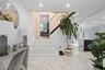 Staircase with marble finish floors and recessed lighting