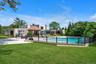 View of pool with a patio and a deck