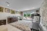 Main floor Bedroom or office with crown molding, light tile patterned floors, and recessed lighting