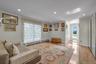 Bedroom with ensuite bath with light wood flooring, ornamental molding, and recessed lighting