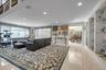 Living Room with plenty of natural light, light tile patterned floors, recessed lighting, and crown molding