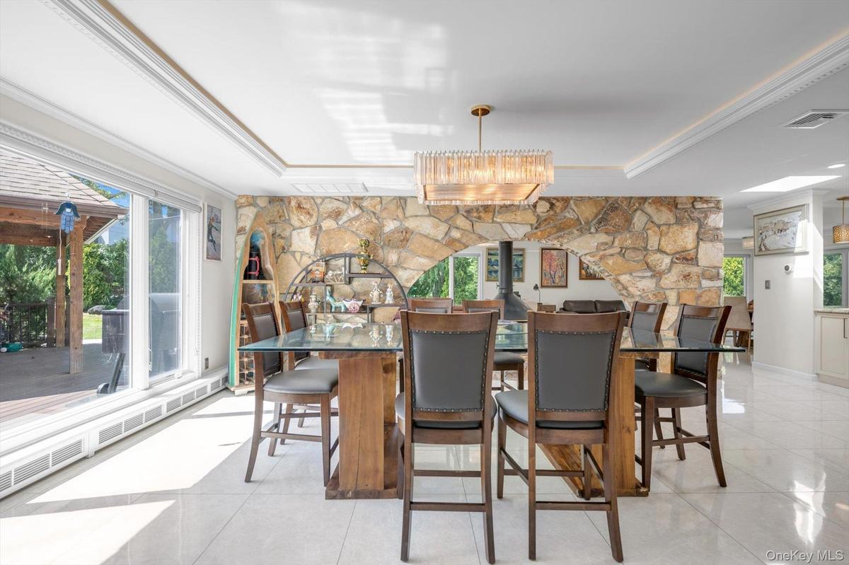 Dining Room with a raised ceiling, plenty of natural light, and ornamental molding