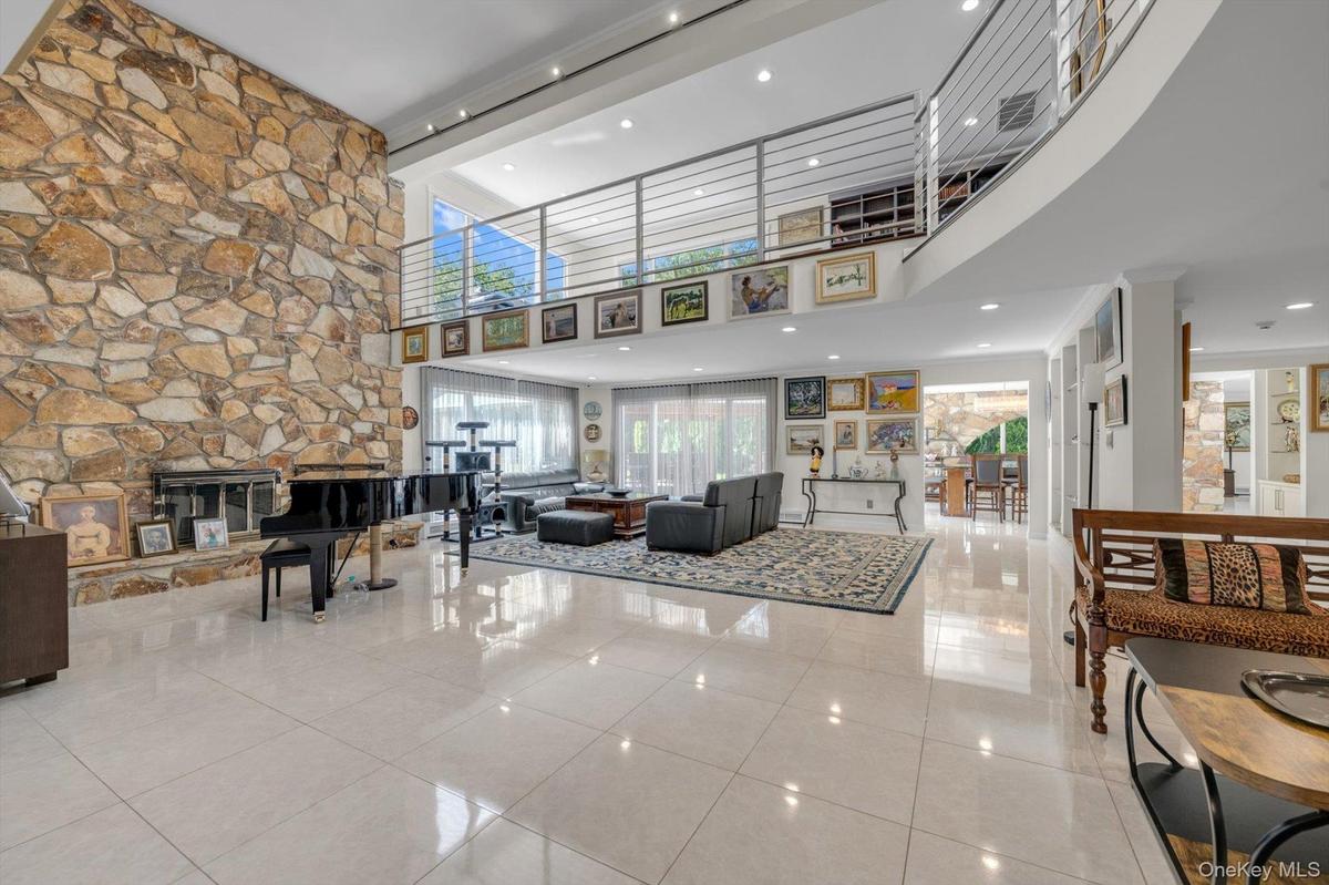 Living Room fireplace and two story ceiling with recessed lighting