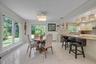 Breakfast area featuring crown molding and light tile patterned floors