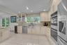 Kitchen with wood cabinets, tasteful backsplash, stainless steel appliances, light tile patterned floors, and recessed lighting