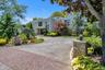 View of front of house featuring stucco siding and circular driveway