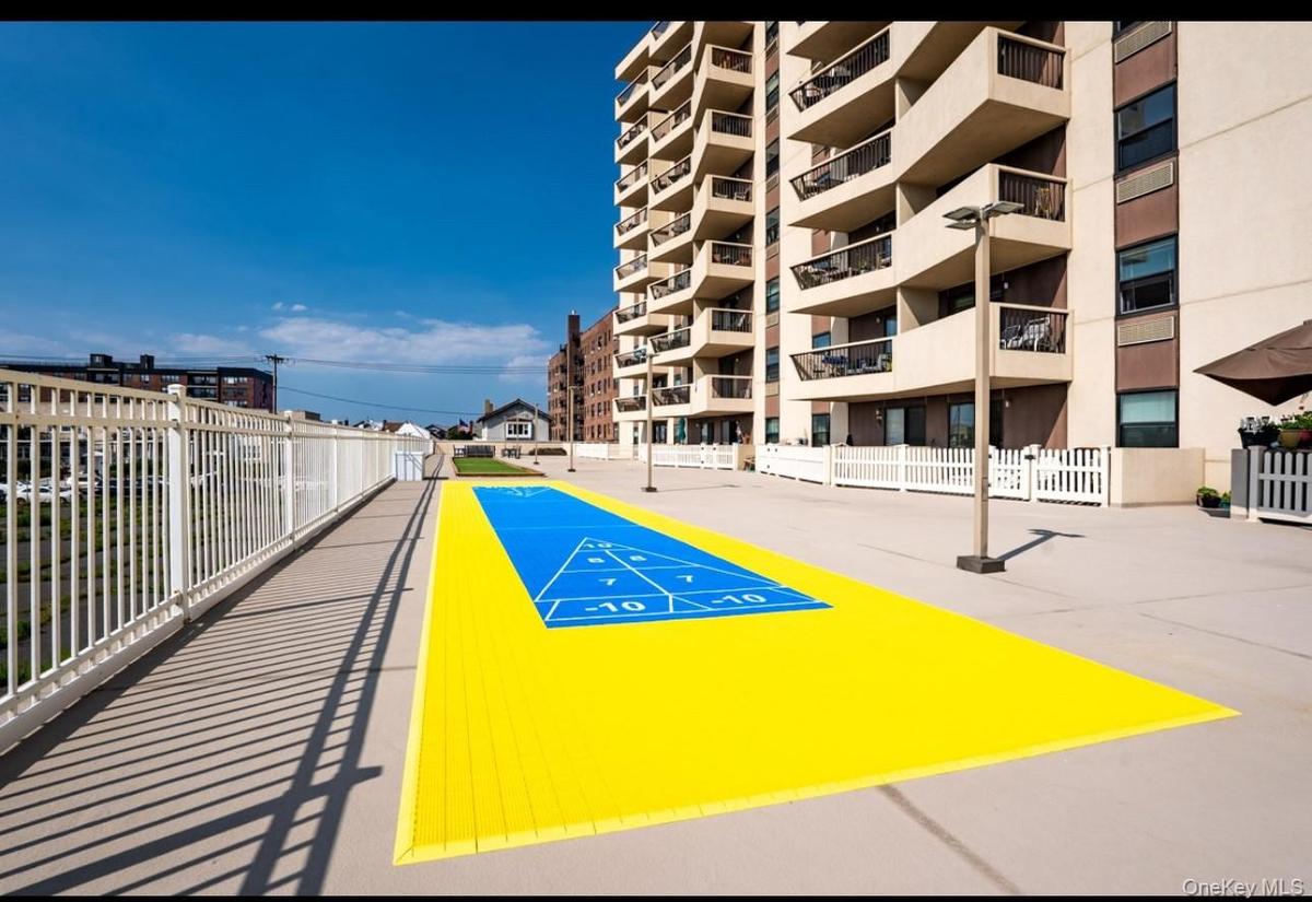 View of property's community with shuffleboard