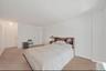 Bedroom with light carpet