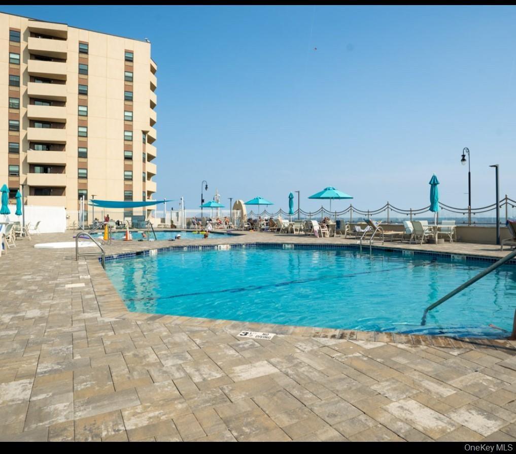 Community pool featuring a patio