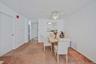 Dining area with light colored carpet and ceiling fan