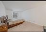 Bedroom with carpet flooring and baseboards
