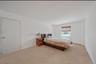 Bedroom featuring carpet flooring and baseboards