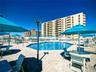Community pool with a patio