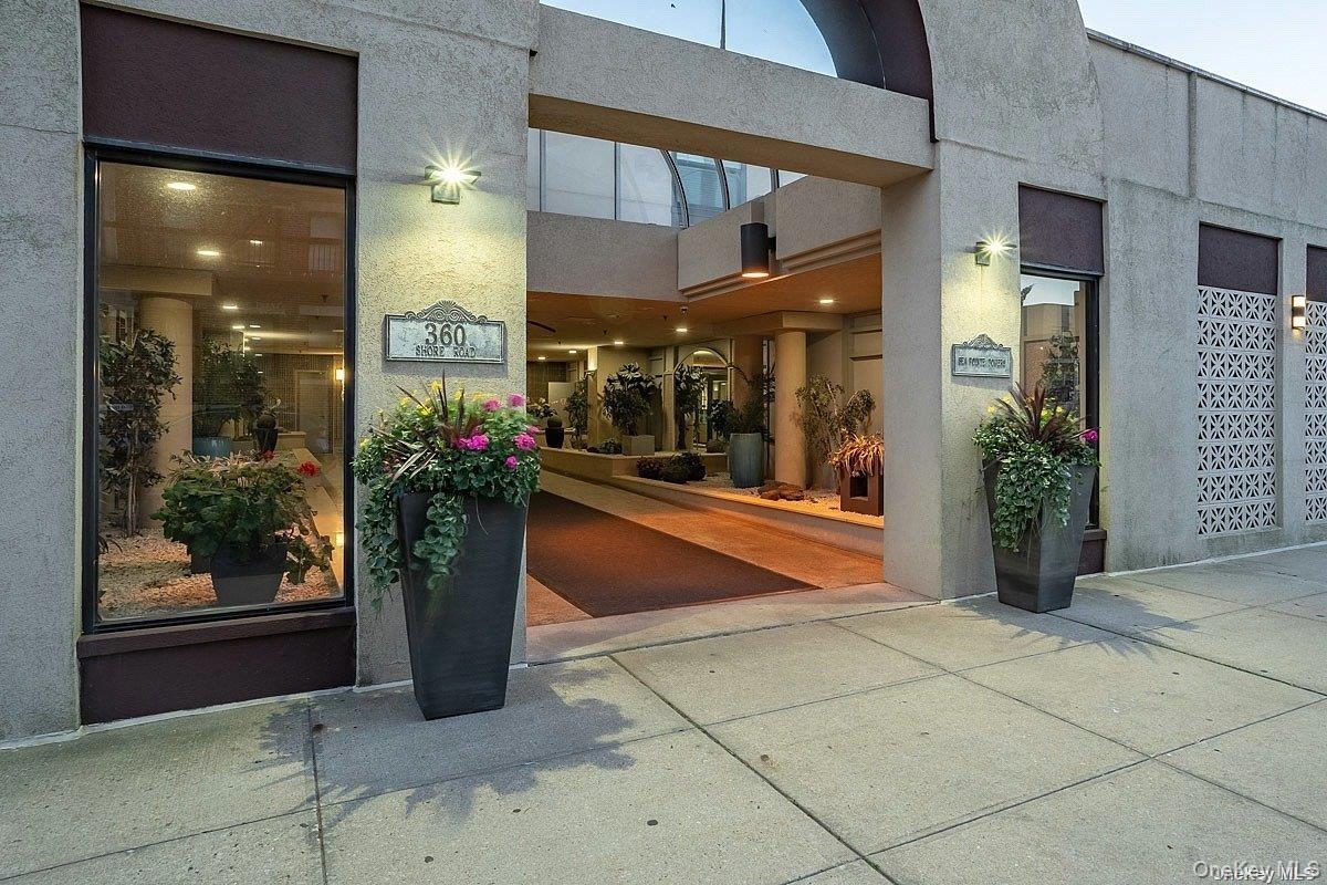 Entrance to property featuring stucco siding