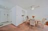 Dining room with light carpet, light tile patterned floors, and ceiling fan