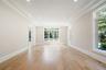 Empty room featuring light wood-style flooring, plenty of natural light, recessed lighting, a raised ceiling, and crown molding