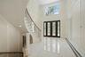 Foyer entrance featuring french doors, plenty of natural light, a decorative wall, a high ceiling, and recessed lighting