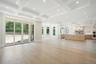 Unfurnished living room with coffered ceiling, beamed ceiling, recessed lighting, light wood-style flooring, and crown molding
