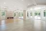 Unfurnished living room with beam ceiling, coffered ceiling, a fireplace, and recessed lighting