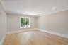 Empty room featuring light wood-style flooring, crown molding, and recessed lighting