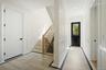 Foyer with a decorative wall, stairway, and ornamental molding